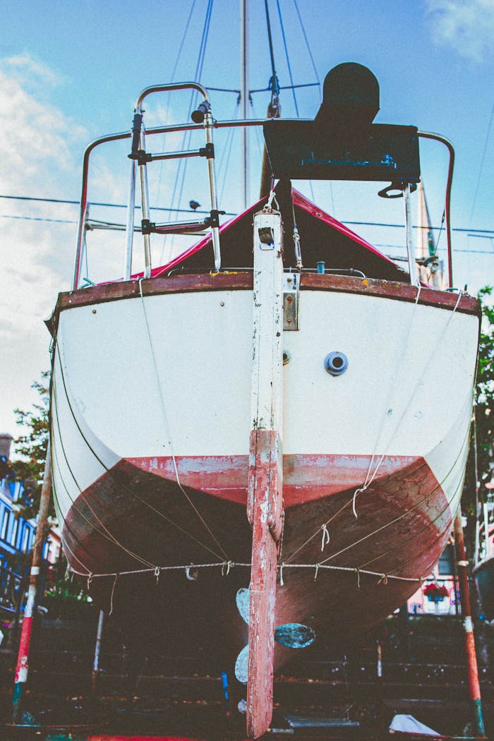 Front view of a vintage sailboat undergoing maintenance at Cobh Harbor, Ireland.